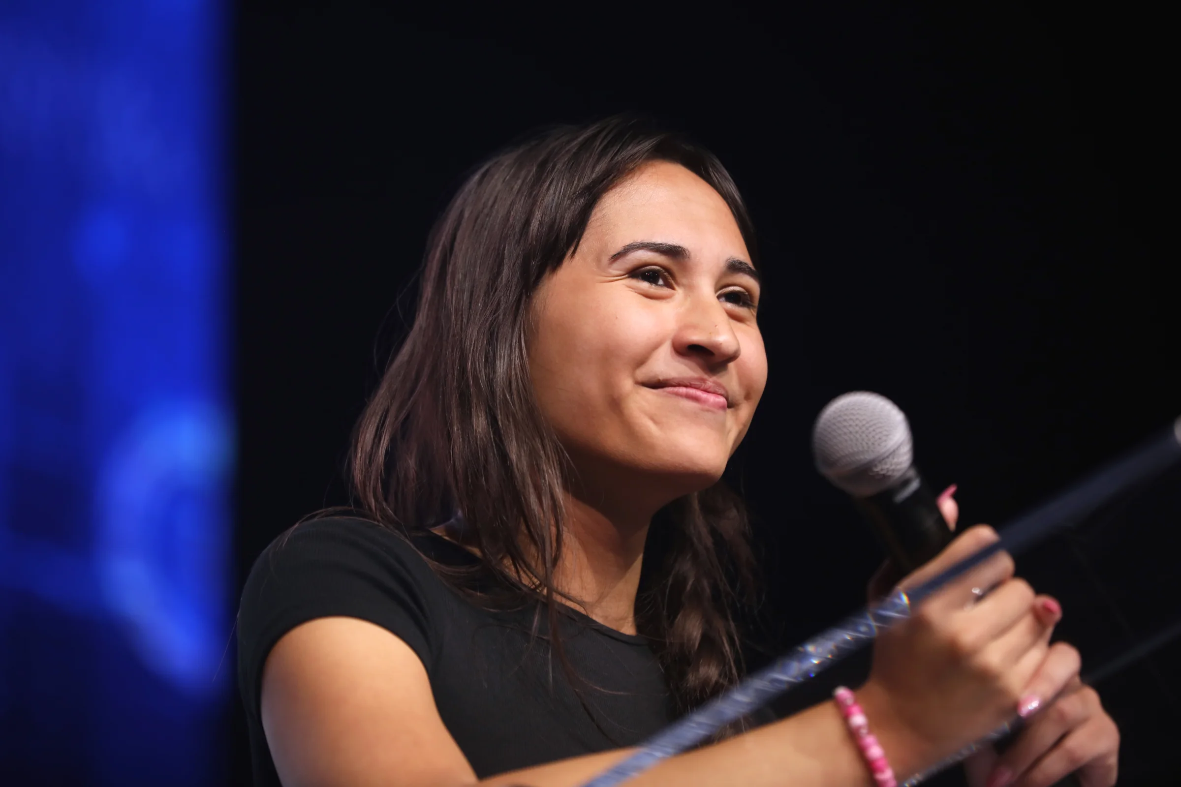 Chloe Cole smiling during a conversation with a microphone